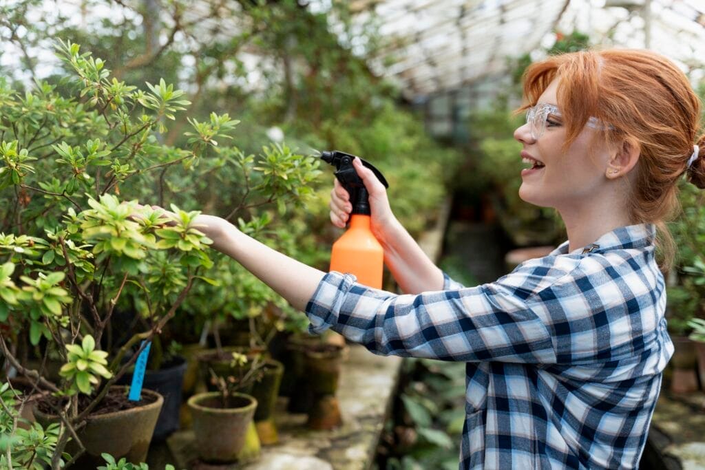redhead woman taking care her plants greenhouse Bahçe Bakımı ve Peyzaj Kursu